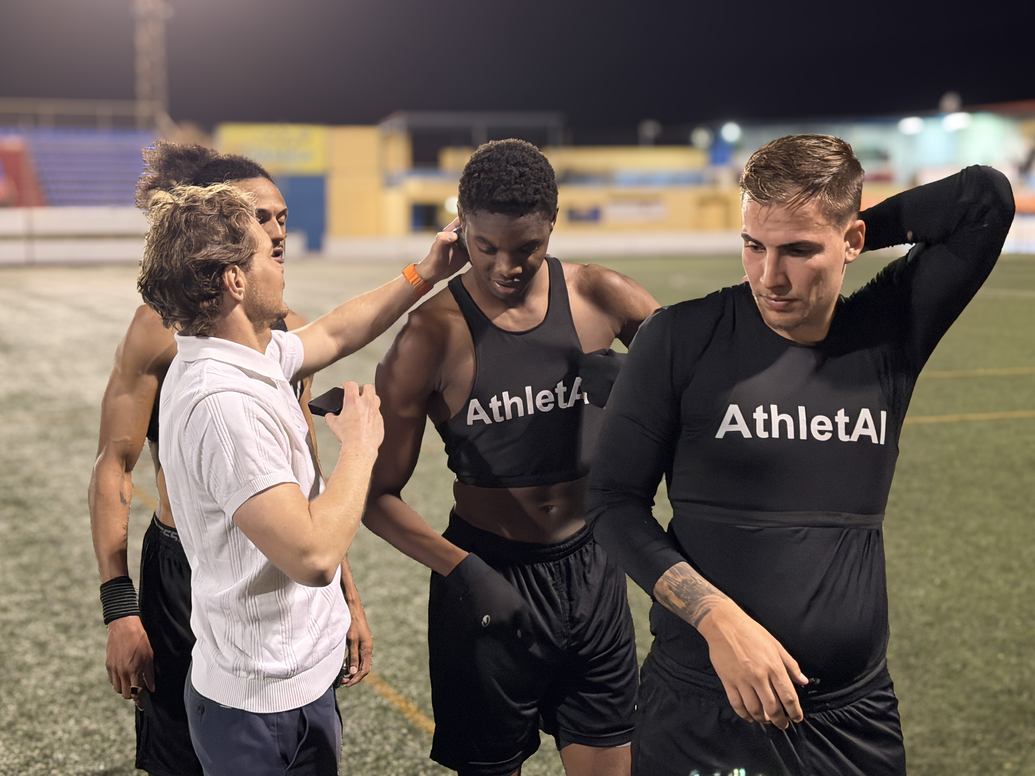 Athletes wearing AthletAI vests during a live field session